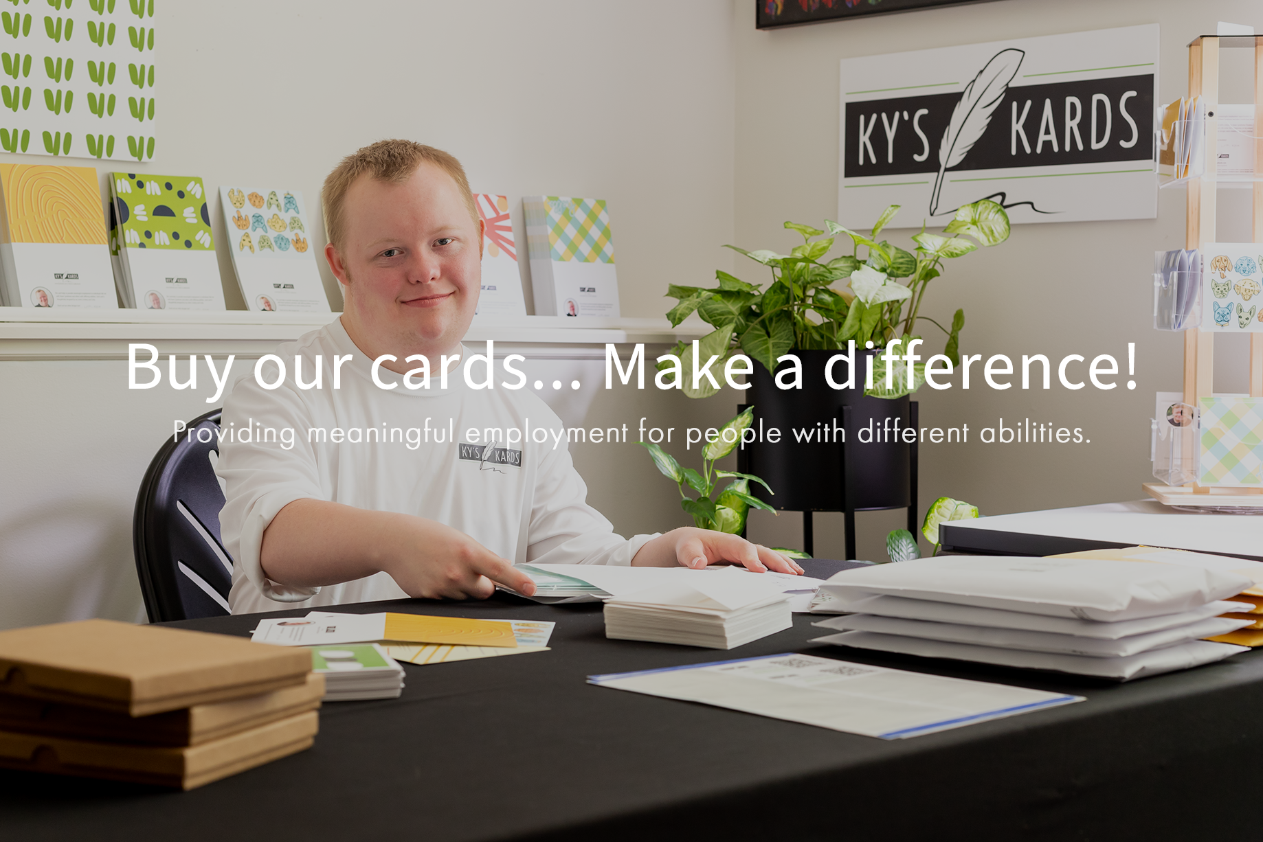 Kyle from Ky's Kards in the office working on packaging greeting cards